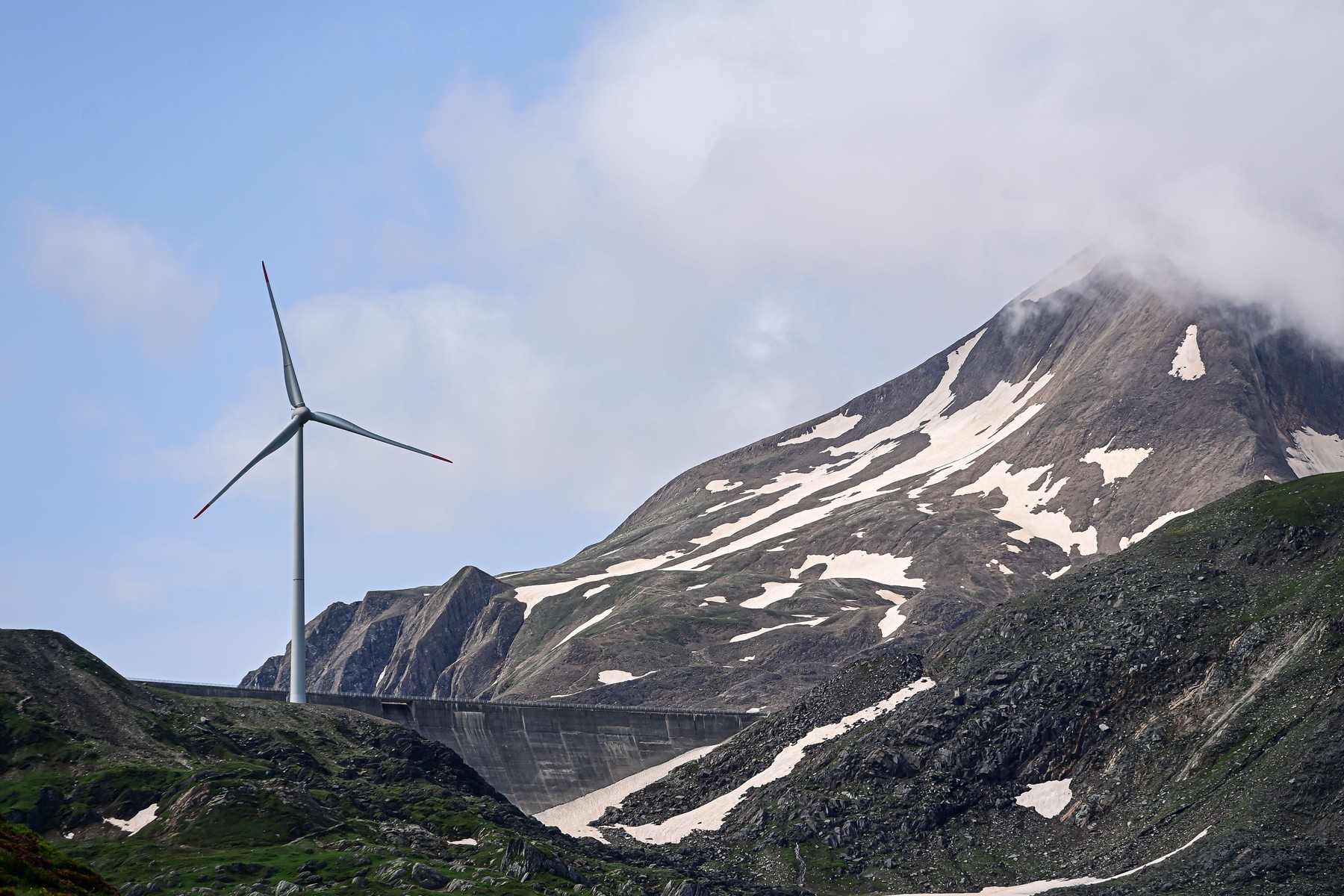 Wind turbine for wind energy amidst clouds at the highest wind farm in Europe on the Nufenen Pass in the Swiss Alps, Ulrichen, Valais, Switzerland, Europe,Image: 892193517, License: Rights-managed, Restrictions: , Model Release: no