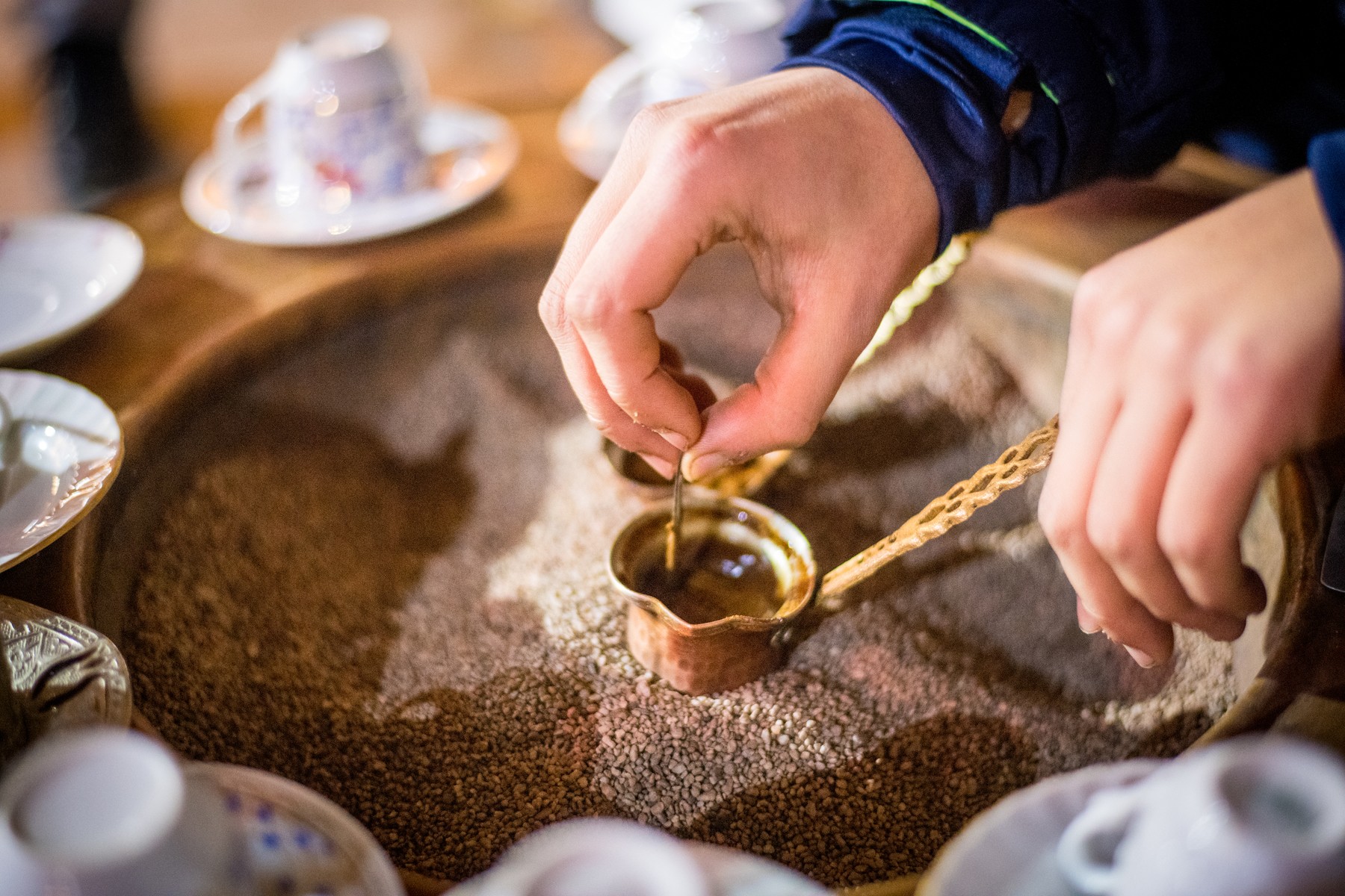 Closeup on hands brewing Turkish coffee in copper cezve pot, Istanbul, Turkey,Image: 954631520, License: Rights-managed, Restrictions: Maryland traditions, Model Release: no