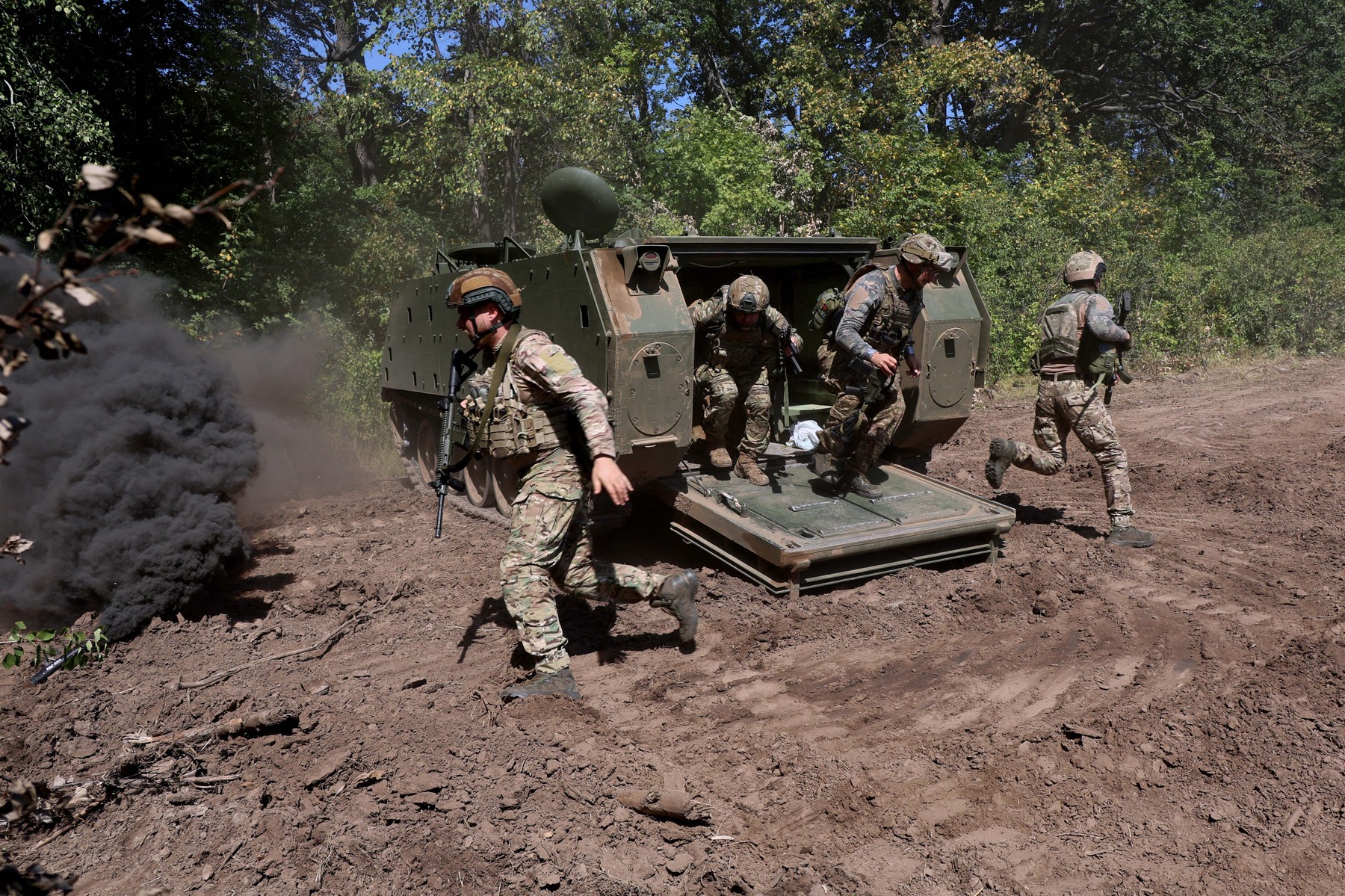 Infantrymen of the operational battalion of the 13th Brigade of the National Guard of Ukraine ?Khartiia? practice airborne skills using an American M113 tracked armored personnel carrier, Kharkiv region, Ukraine, on August 29,
