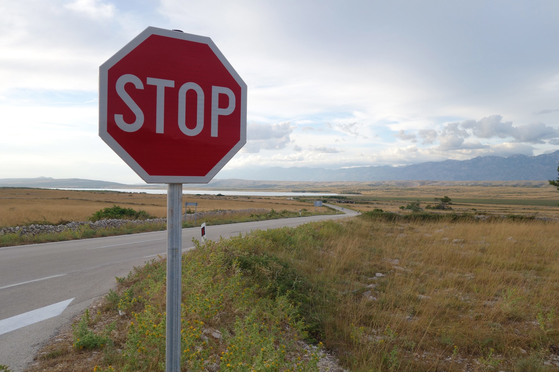 A stop sign on a country road on the island of Pag | usage worldwide,Image: 675582856, License: Rights-managed, Restrictions: , Model Release: no
