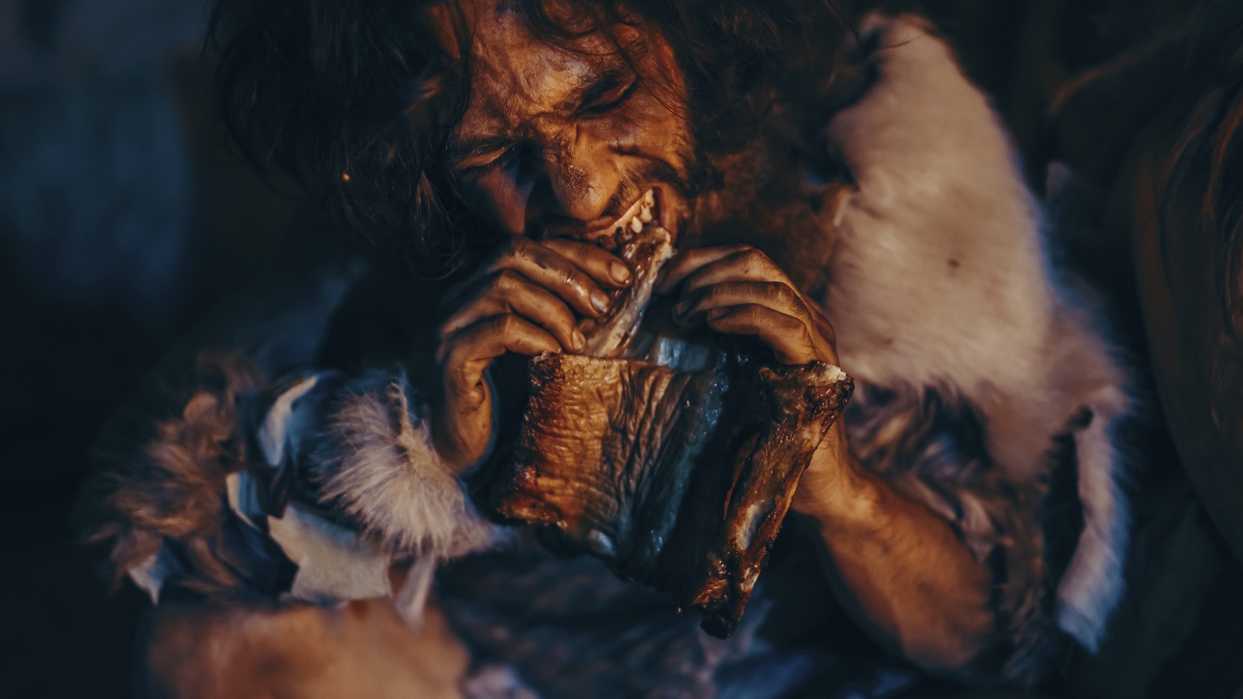 Prehistoric man eating.,Image: 904586363, License: Royalty-free, Restrictions: Model Released35303, Model Release: yes