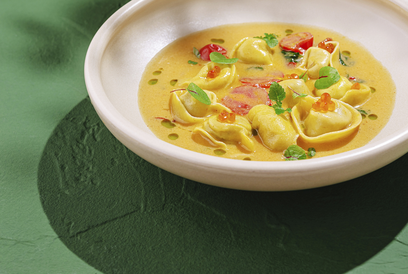 Food, A bowl holds freshly made tortellini immersed in a vibrant creamy sauce, adorned with herbs and garnishes. The dish showcases a blend of colors and flavors,Image: 1019500674, License: Royalty-free, Restrictions: , Model Release: no