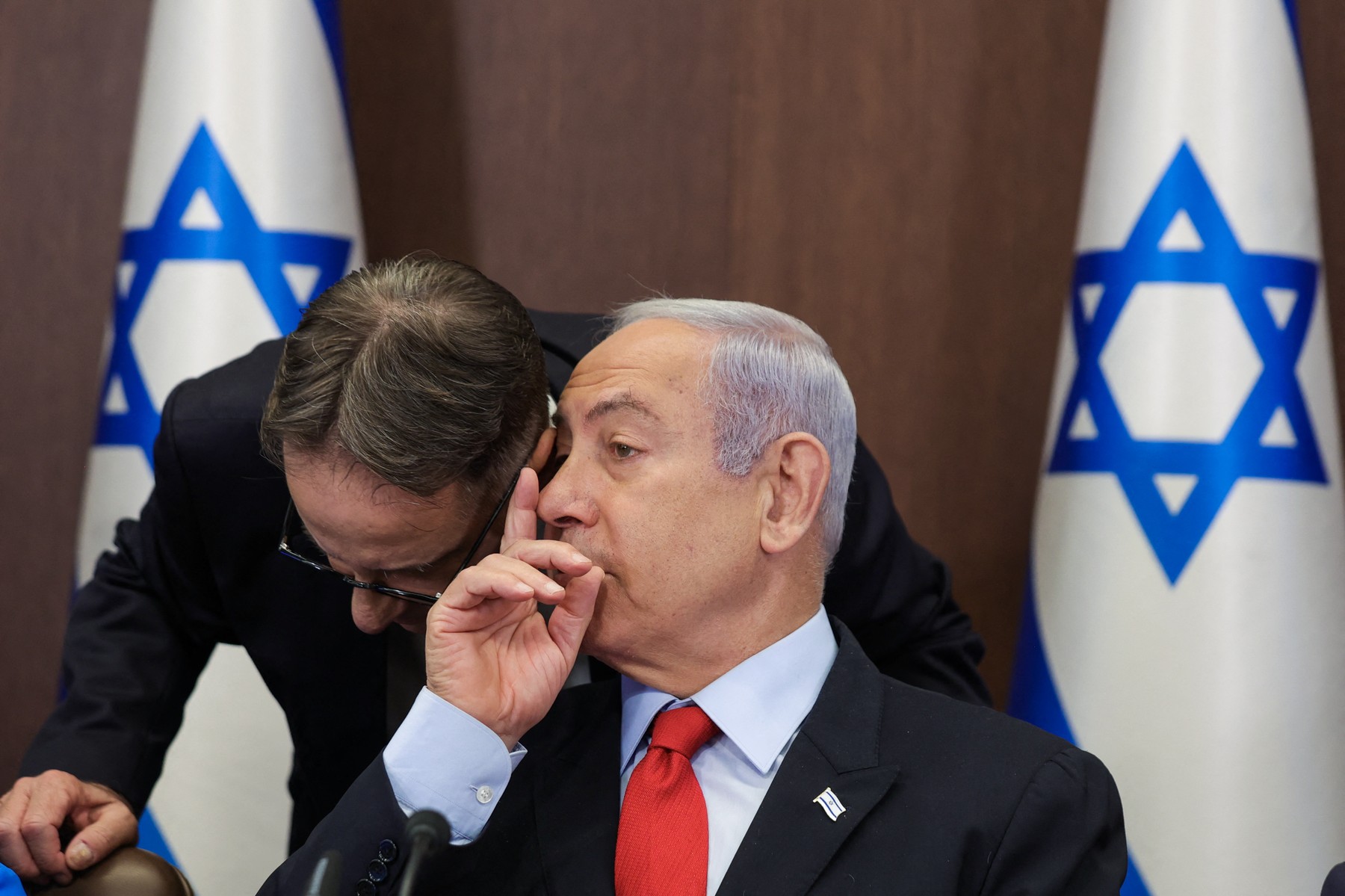 Israel's Prime Minister Benjamin Netanyahu (R) speaks to his chief of staff Tzachi Braverman during the weekly cabinet meeting