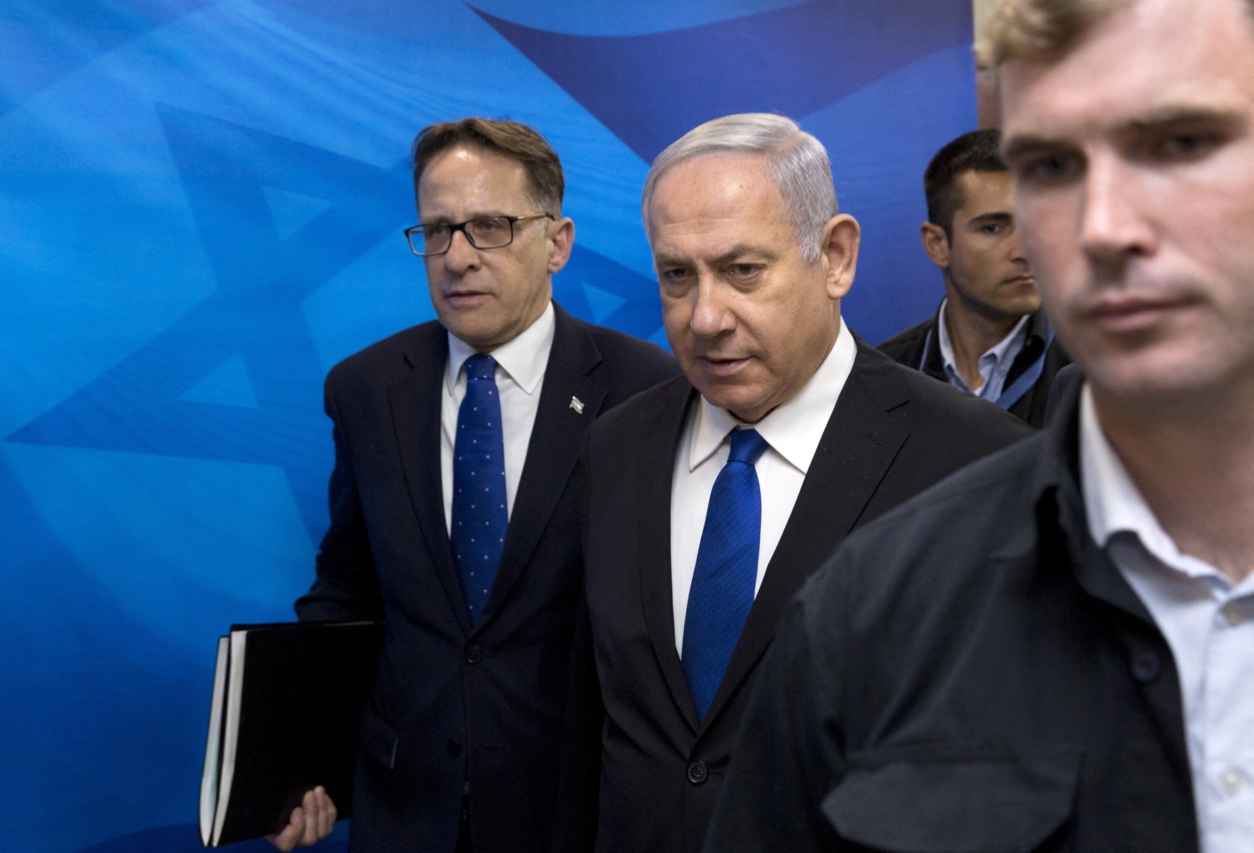Israeli Prime Minister Benjamin Netanyahu (C) arrives with Cabinet Secretary Tzachi Braverman (L) to attend the weekly cabinet meeting in his office in Jerusalem on April 29, 2018.