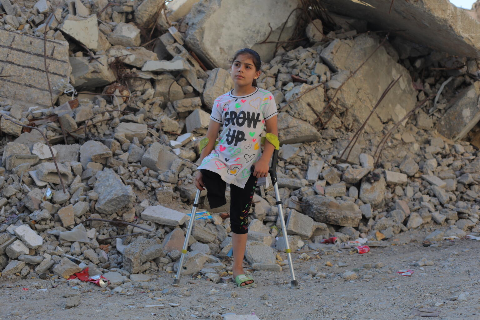 Meral, 9, dreams of walking againNuseirat, Gaza — Sitting on a small plastic chair ou