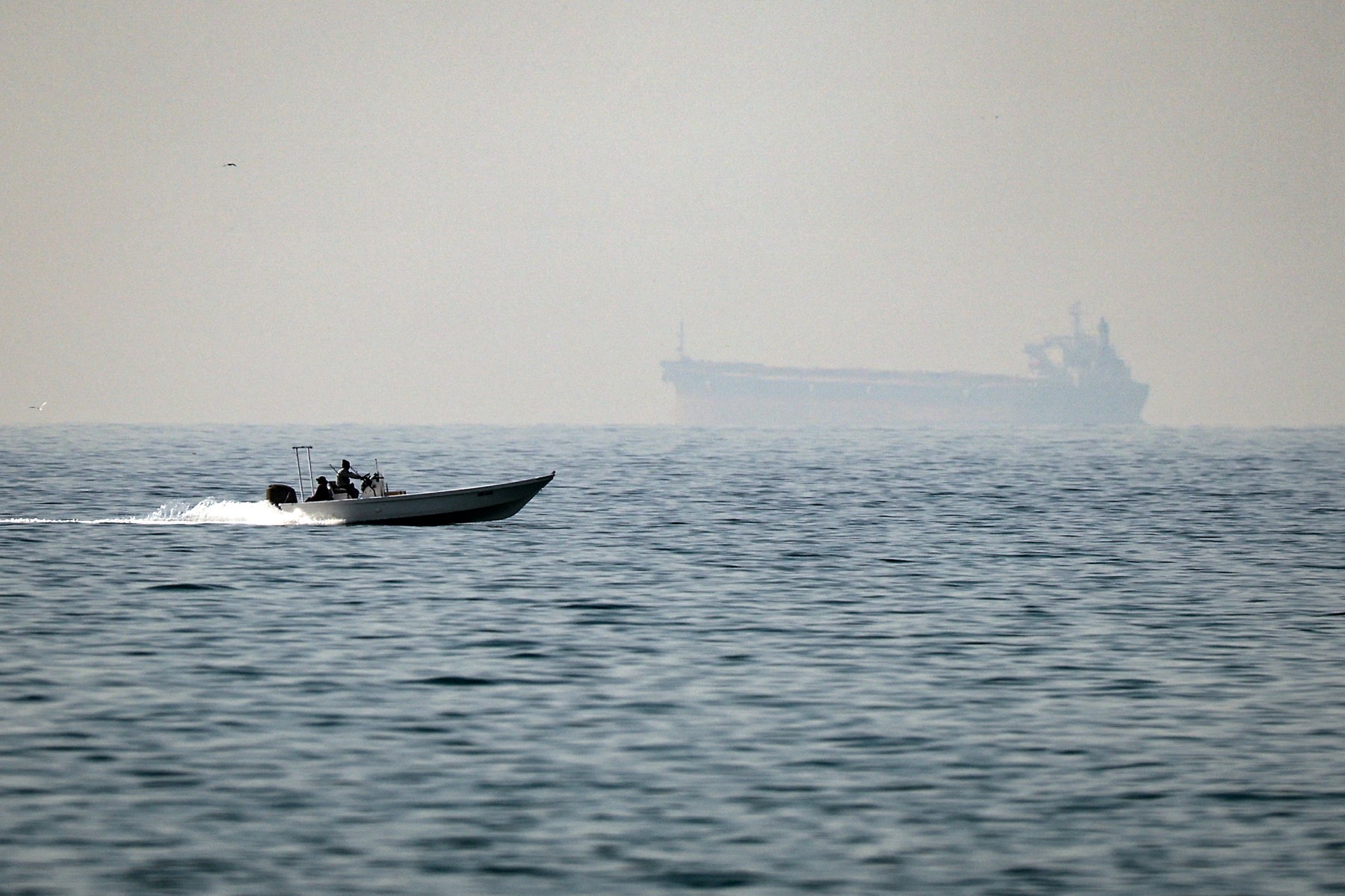 A motorboat cruises along the shore off the town of Al Jeer on the Strait of HormuzFebruary 25, 2026.