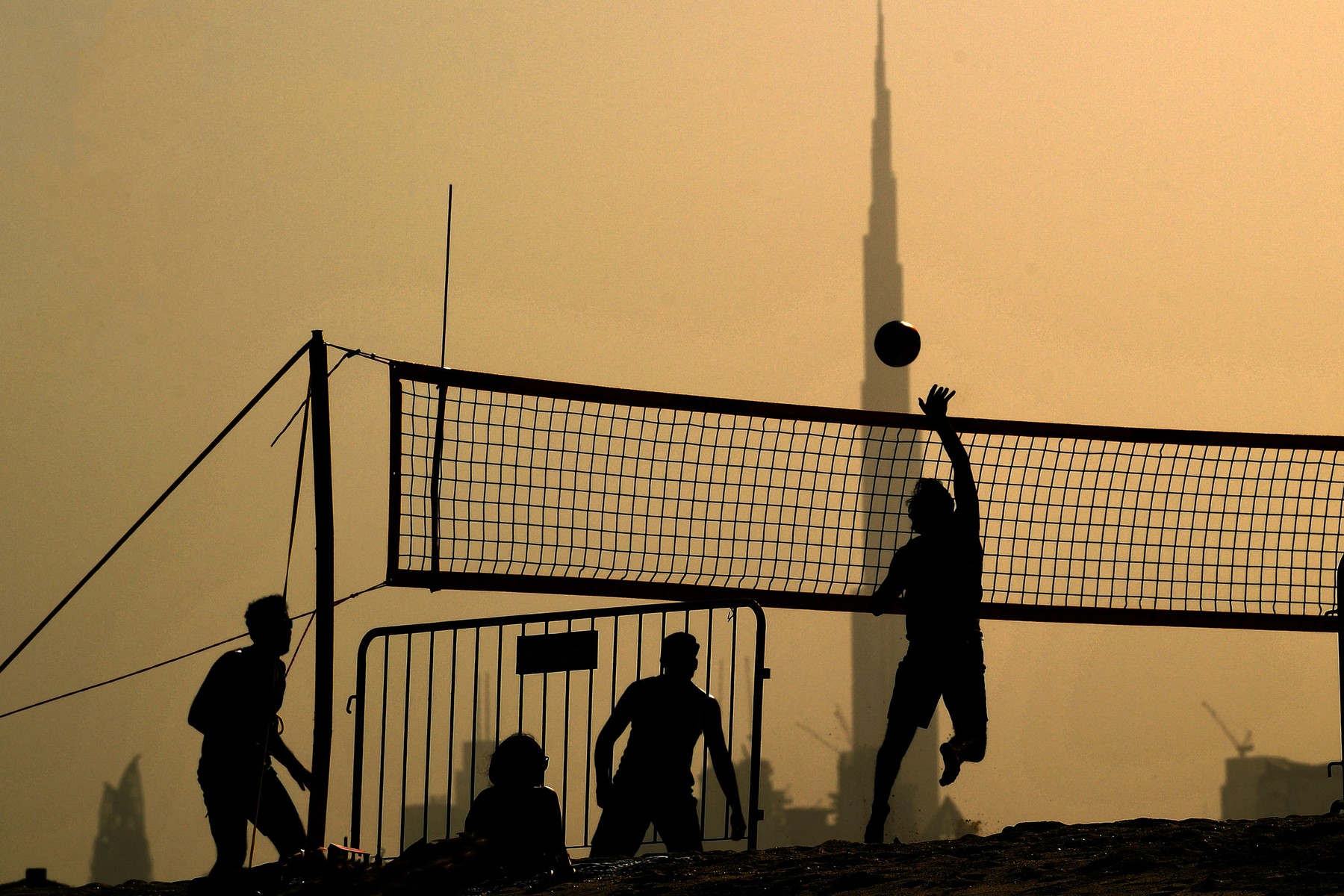 People play during a beach volleyball tournament in the Gulf emirate of Dubai on July 24, 2020