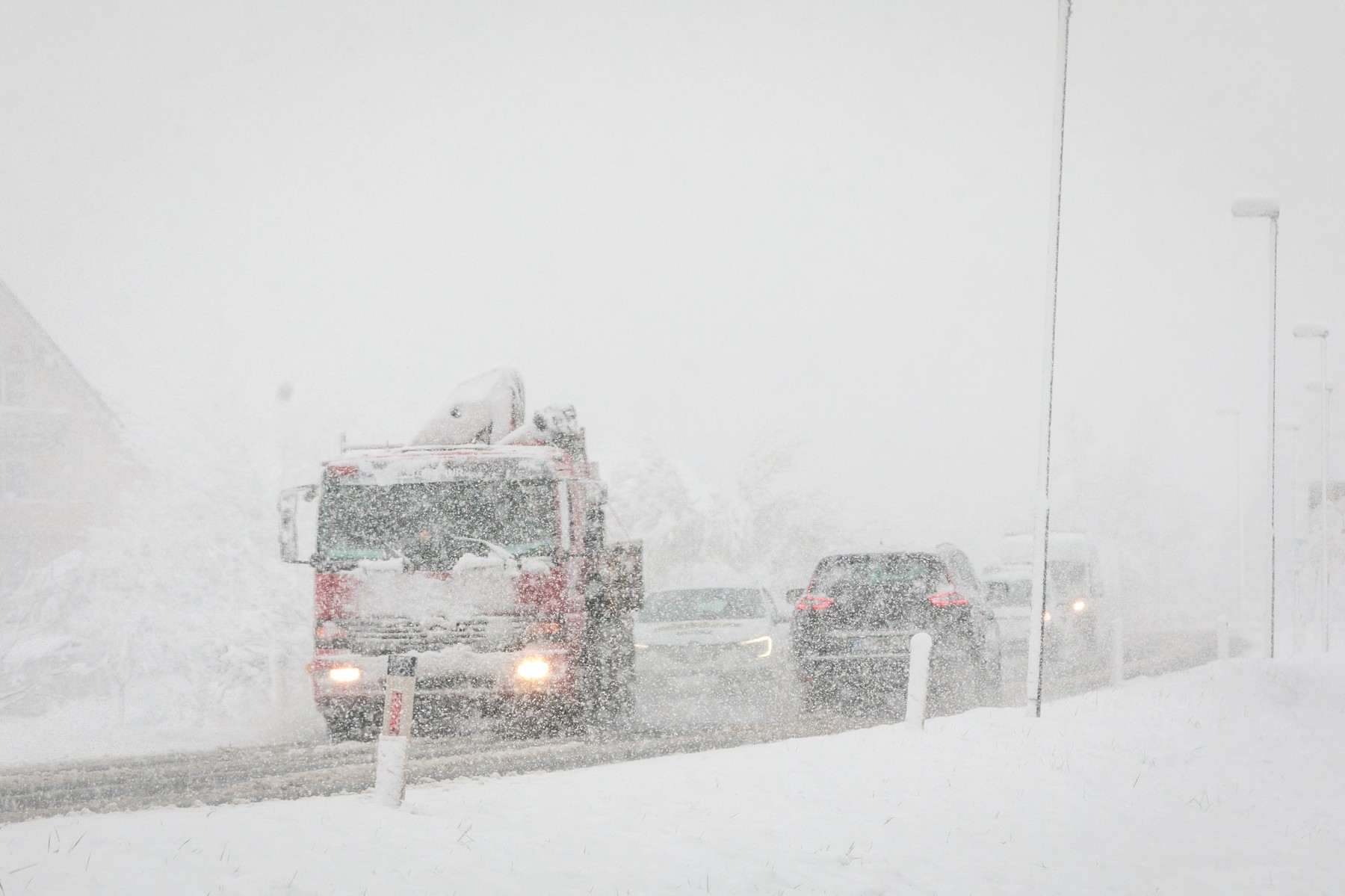 LJUBLJANA, SLOVENIA - APRIL 06: Traffic jam is seen on a snow covered road during snowfall at the beginning of the spring season in Ljubljana, Slovenia