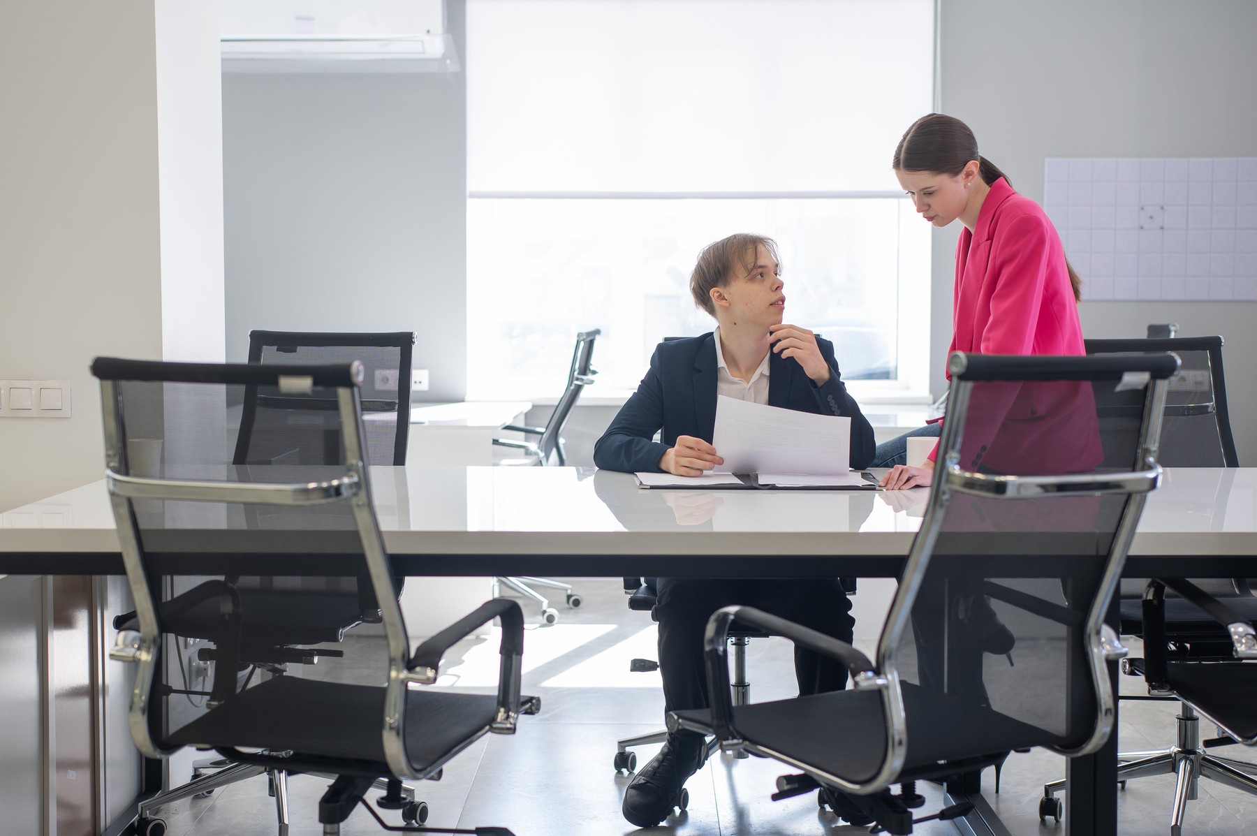 Caucasian woman giving instructions to subordinate