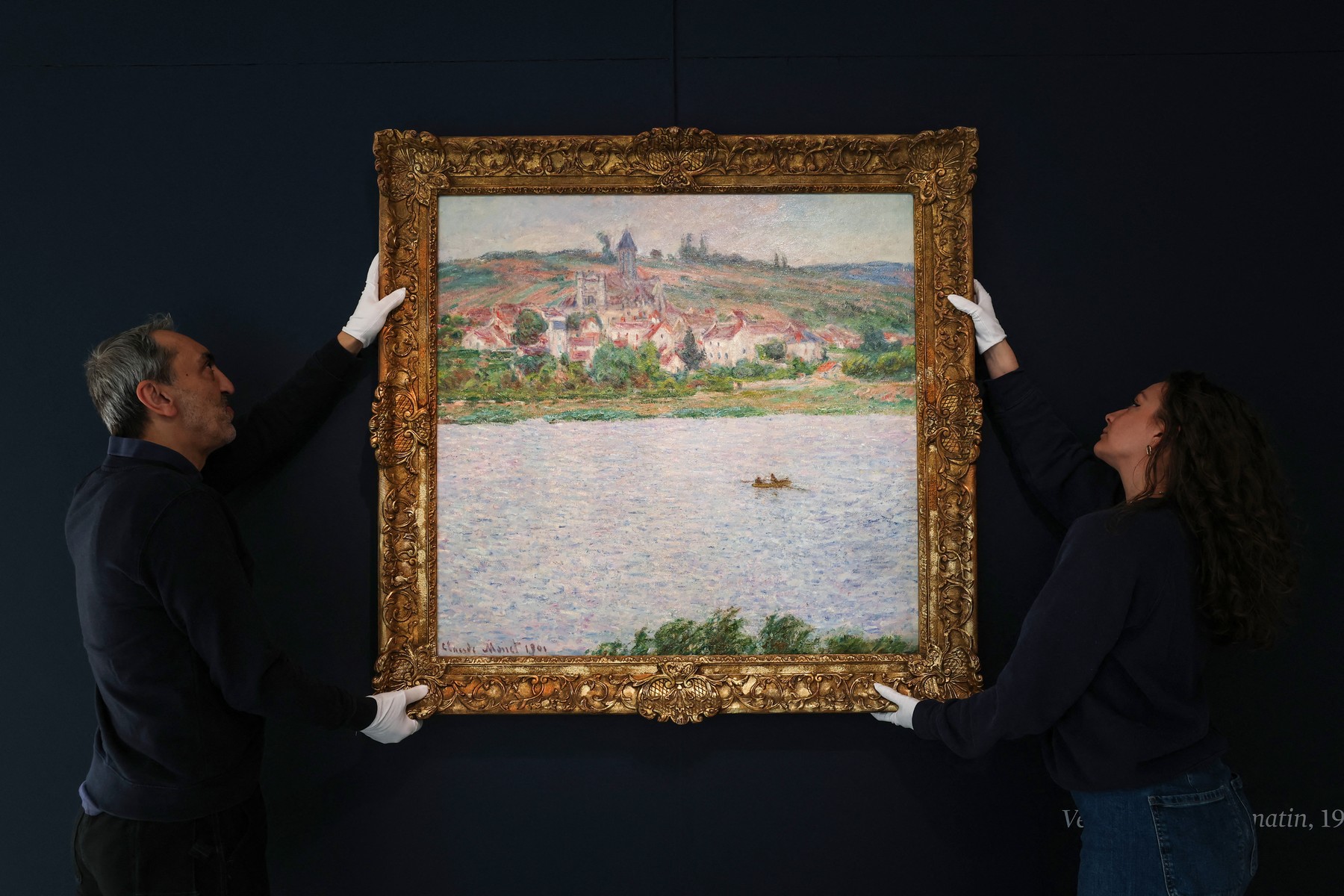 (FILES) Employees of the Sotheby's auction house handle the painting "Vétheuil, Effet du Matin (1901)" by French Impressionist painter Claude Monet