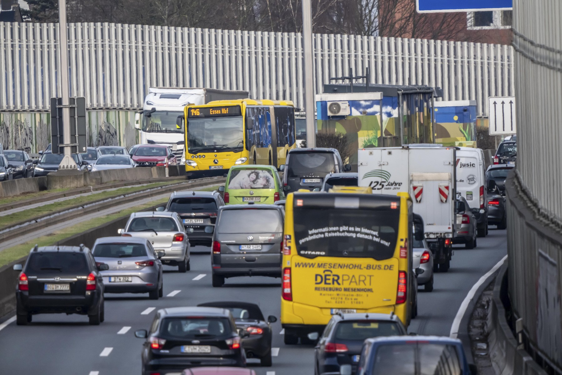 Heavy traffic on the A40 motorway, Ruhrschnellweg, height of the Essen-Ost motorway junction, looking east, 6-lane motorway, with 2 bus lanes in the middle, rush hour traffic, North Rhine-Westphalia, Germany
