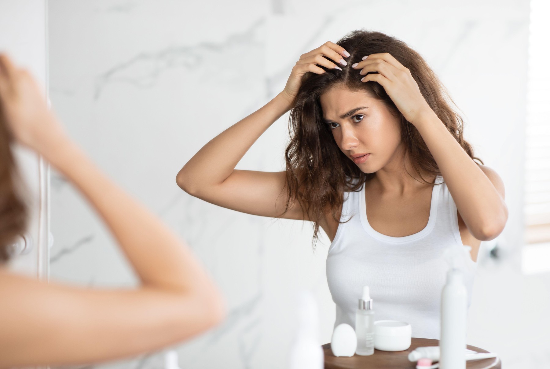 Frustrated Young Lady Searching Hair Flakes Suffering From Dandruff Problem Standing Near Mirror In Bathroom Indoors. Haircare And Head Skin Health Concept. Selective Focus,Image: 1001540230, License: Royalty-free, Restrictions: , Model Release: no
