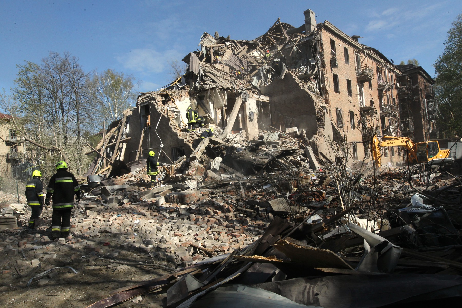 Rescuers search for survivors under the rubble of a four-storey apartment block destroyed by a Russian missile strike in Dnipro, Ukraine, April 25, 2026.