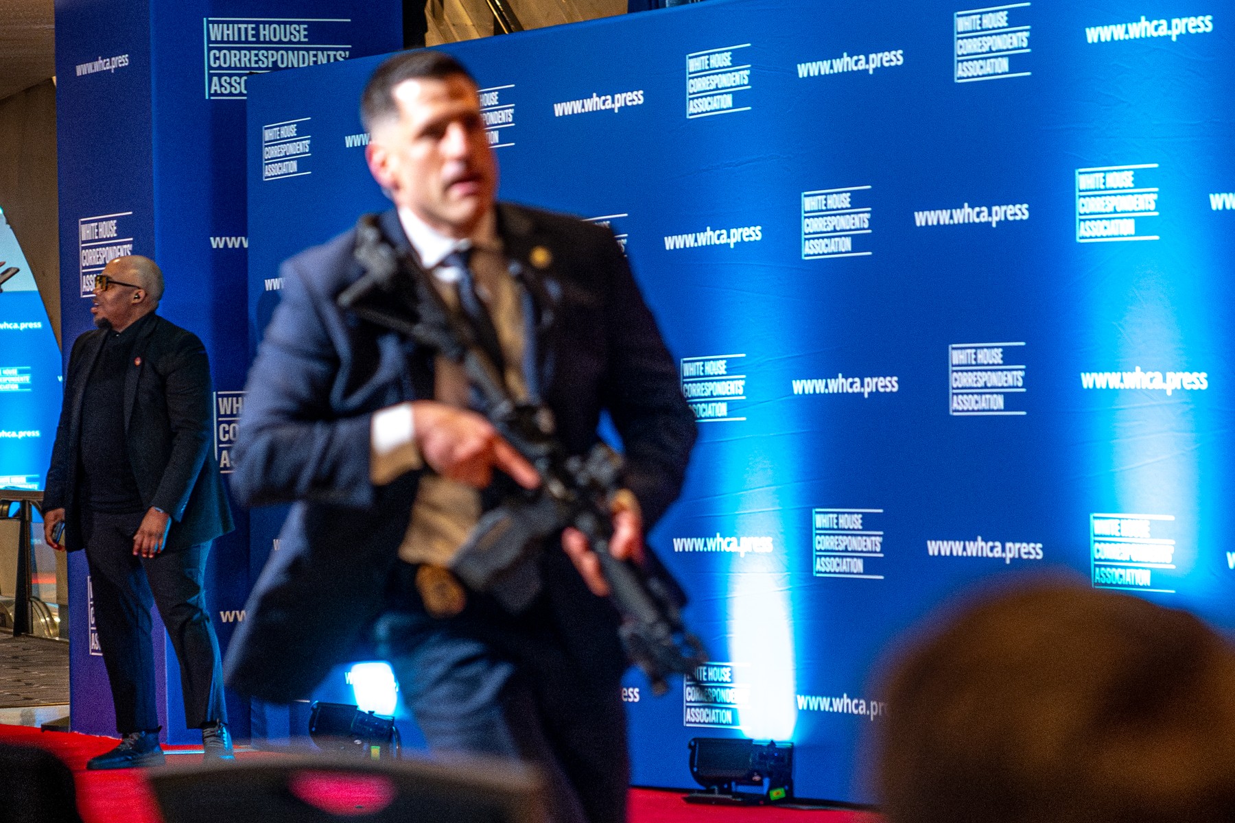 Secret Service agents rush to secure a scene in the Washington Hilton after shots were heard during the White House Correspondents' Dinner