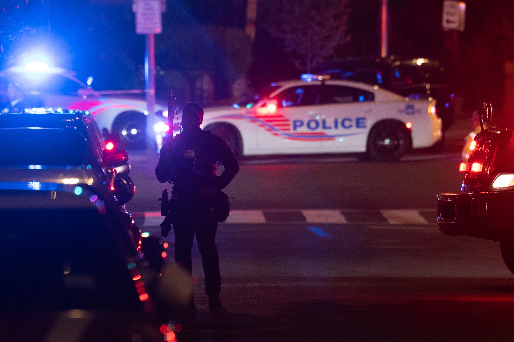 Police officers patrol outside the Washington Hilton after shots