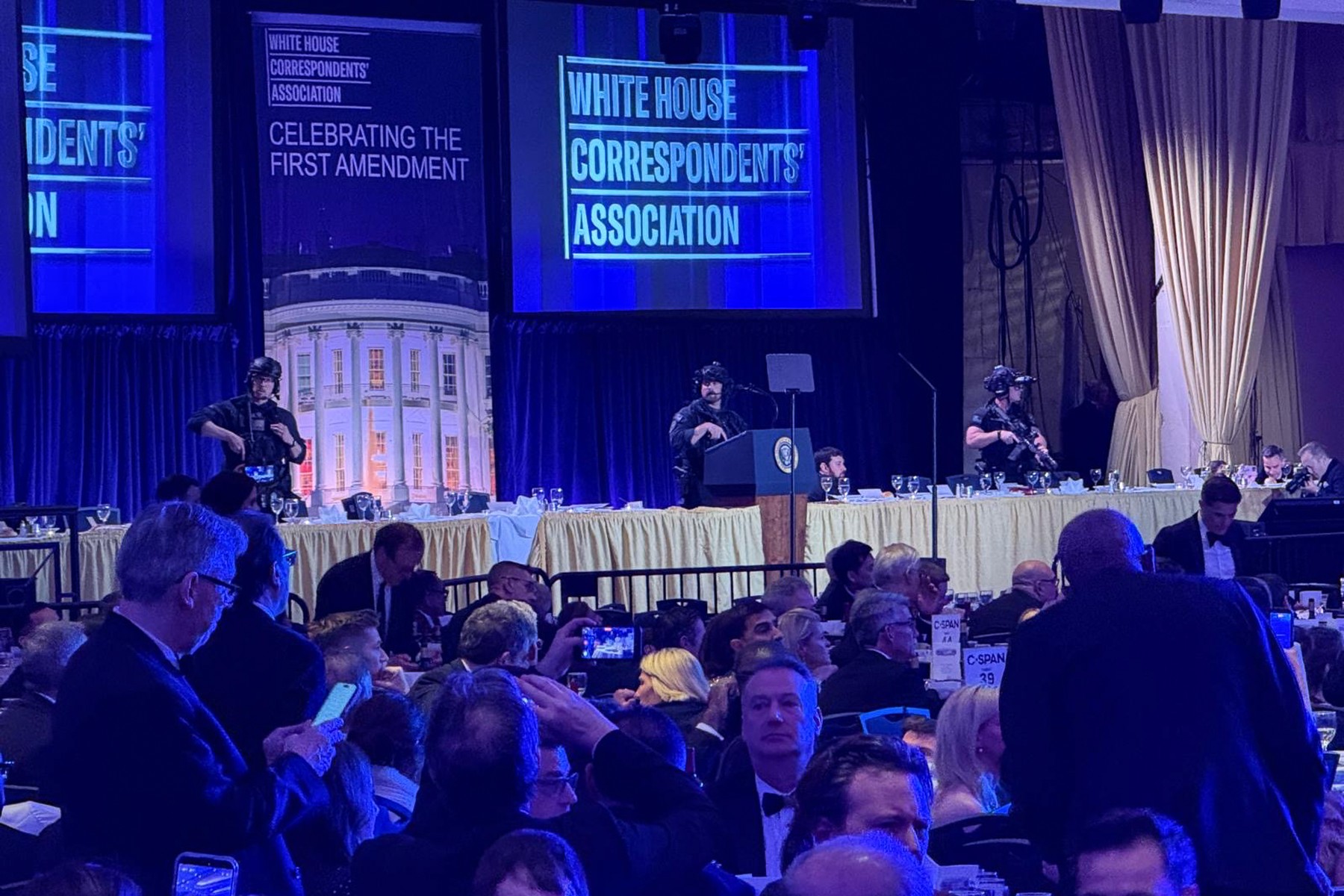 Secret Service agents rush to secure the room after shots were fired during the White House Correspondents Dinner at the Washington Hilton hotel