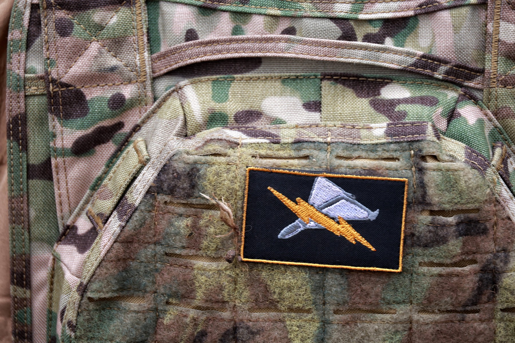 A tactical patch attached to a plate carrier worn by a serviceman of the 208th Kherson Anti-Aircraft Missile Brigade