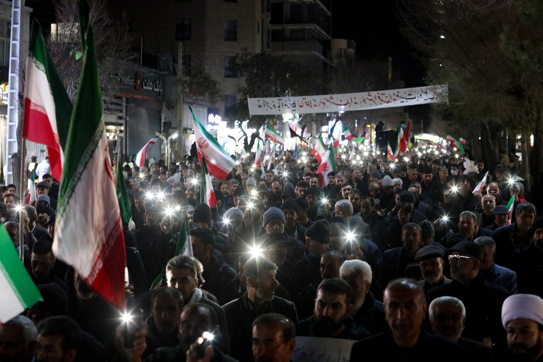 March 17, 2026, Iran: Pro-government supporters wave Iranian flags during a night rally.