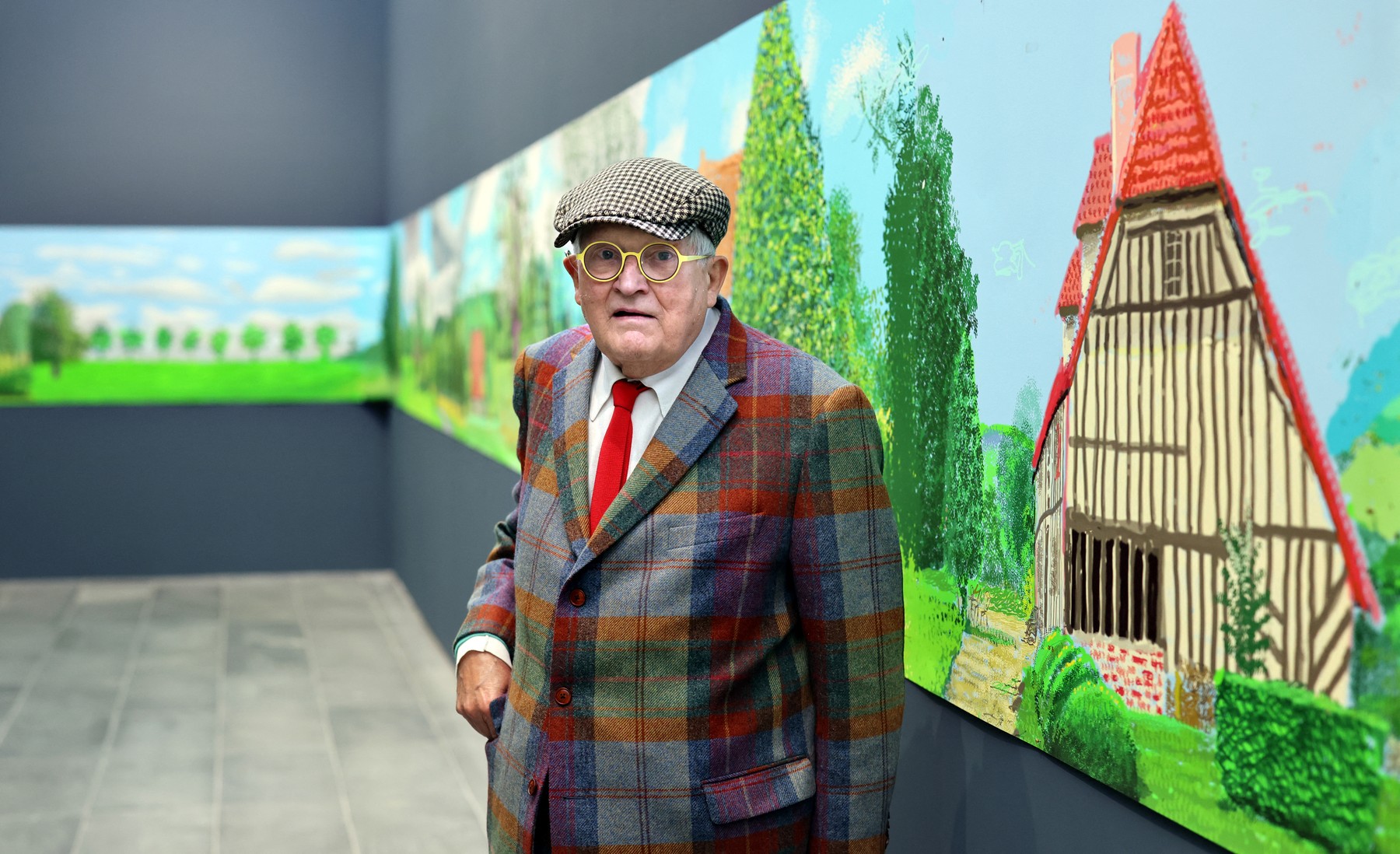 (FILES) British painter David Hockney poses at the Orangerie museum in Paris, on October 7, 2021, in front of his painting "A year in Normandy", a 91-meter-long artwork painted during the lockdown in 2020.