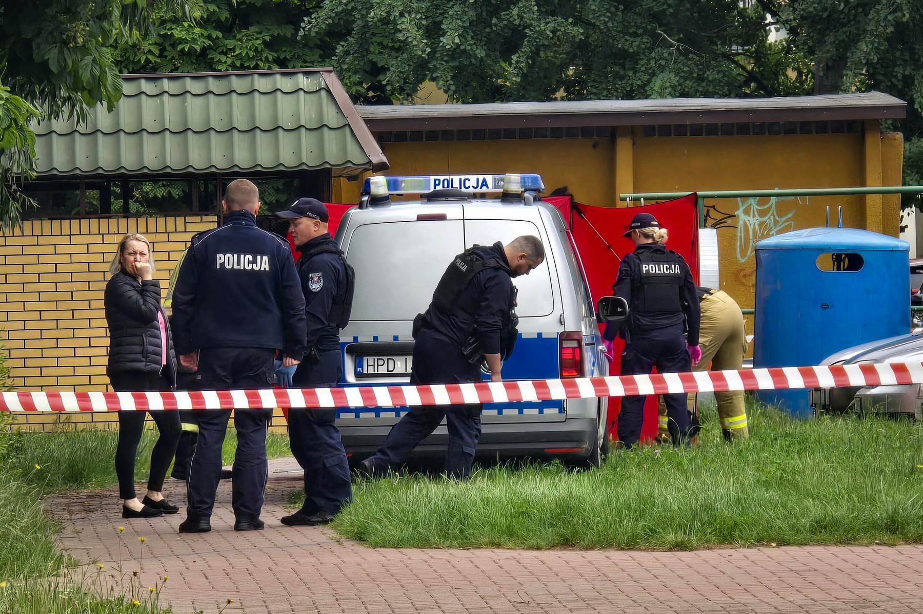 Police work at a crime scene covered with a tent.