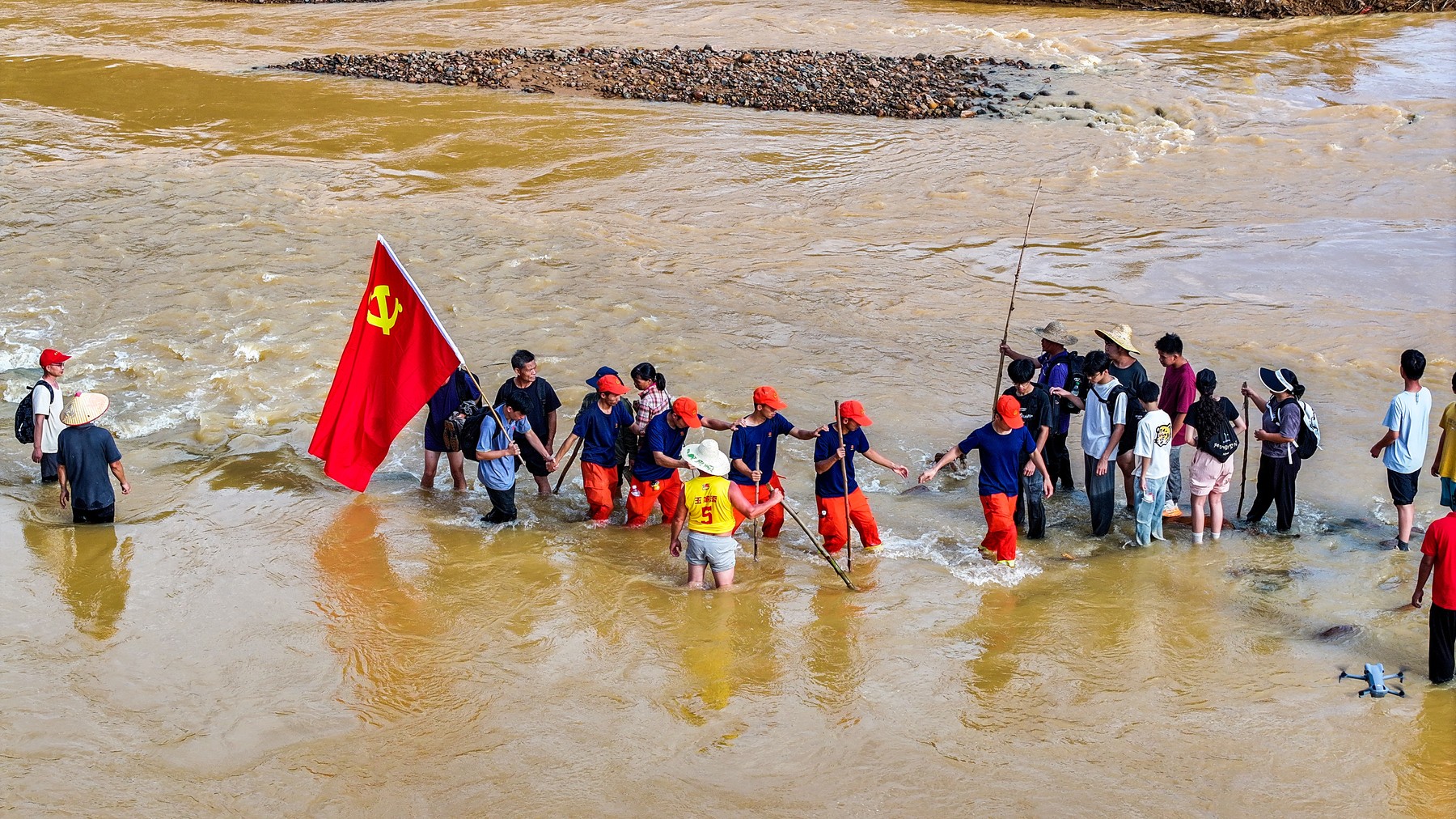 NANNING, July 11, 2026 -- An aerial drone photo shows rescuers heading towards Zhenlong Township of Hengzhou, south China's Guangxi Zhuang Autonomous Region, July 11, 2026.