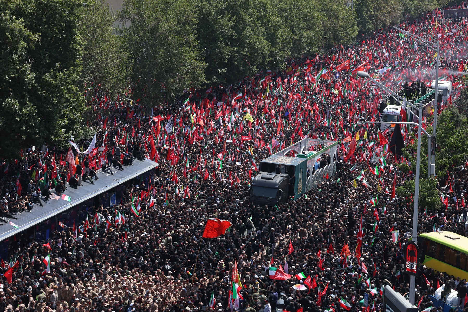 People gather along a street during the f