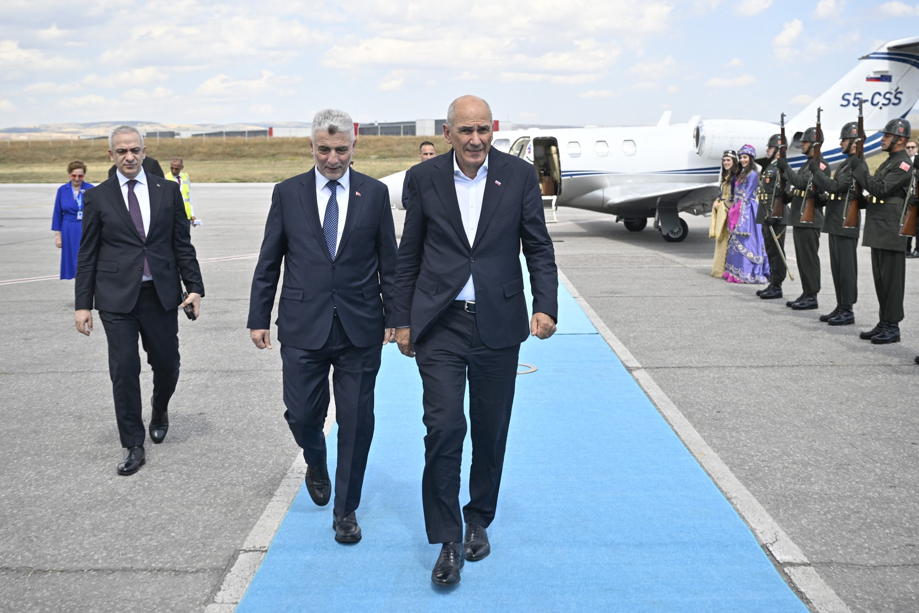 Slovenia's Prime Minister Janez Jansa (R) is welcomed upon his arrival at Ese anboga Airport.