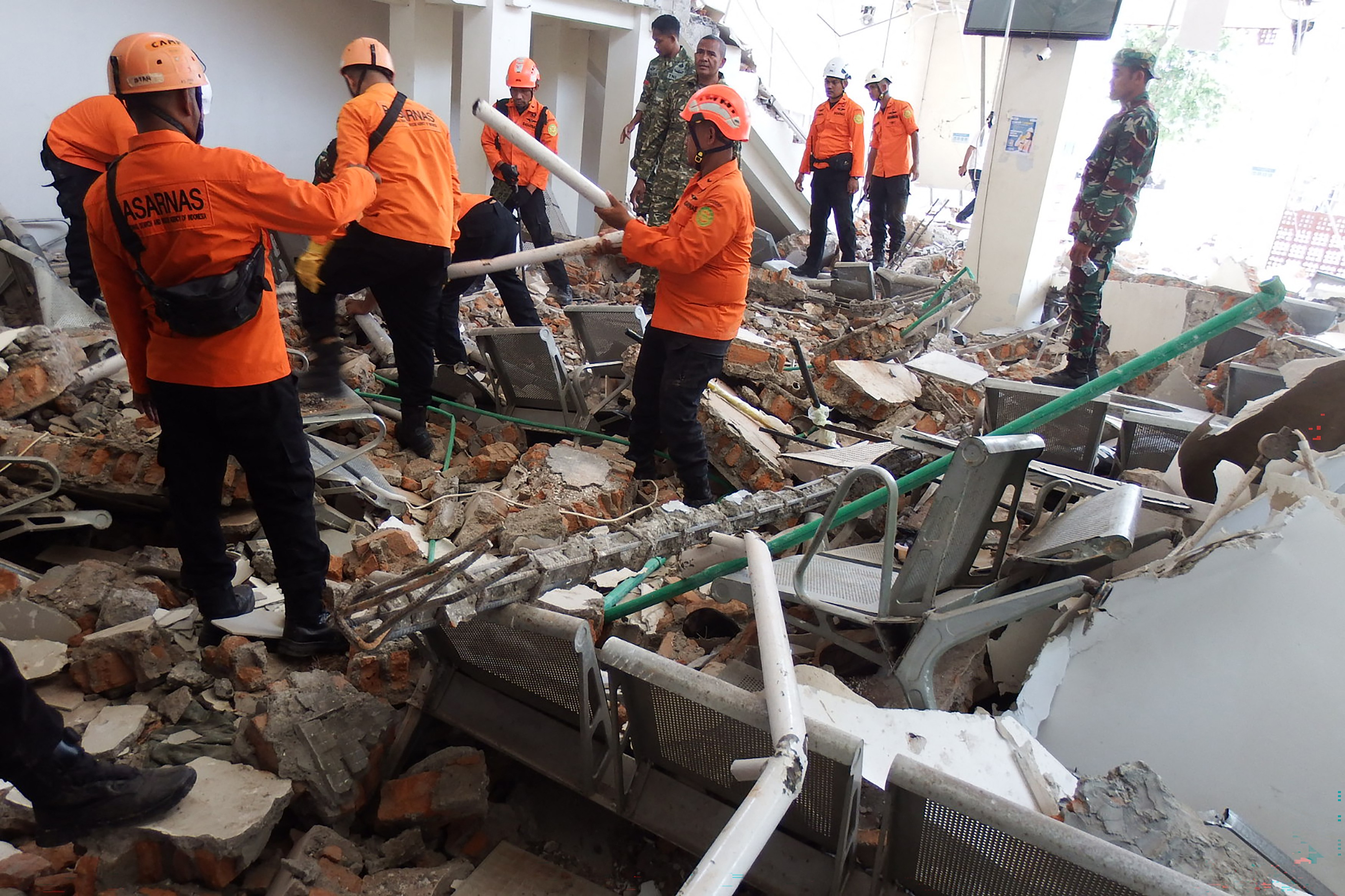 A rescue team searches for victims in Maumere, Sikka, East Nusa Tenggara on August 15, 2026, after a magnitude 7.7 earthquake struck Flores Island.
