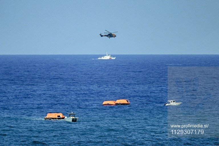 Turkish vessels, aircraft, and rescue rafts are pictured off the port of Kyrenia