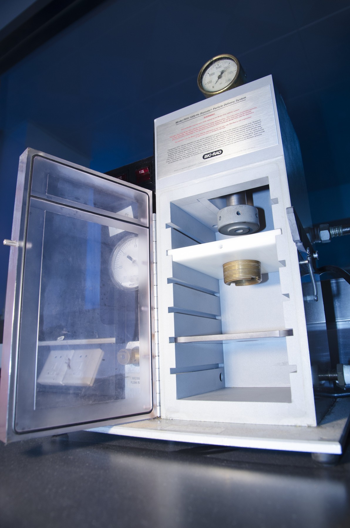 Gene gun in a lab. A gene gun, or a biolistic particle delivery system, is a device for injecting cells with genetic information.
