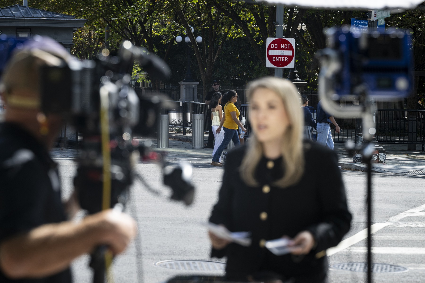 WASHINGTON, DC - SEPTEMBER 19: A do not enter sign behind CNN Senior White House Report Betsy Klein during a television report on a street corner outside the White House grounds after earlier being denied entry, on September 19, 2026 in Washington