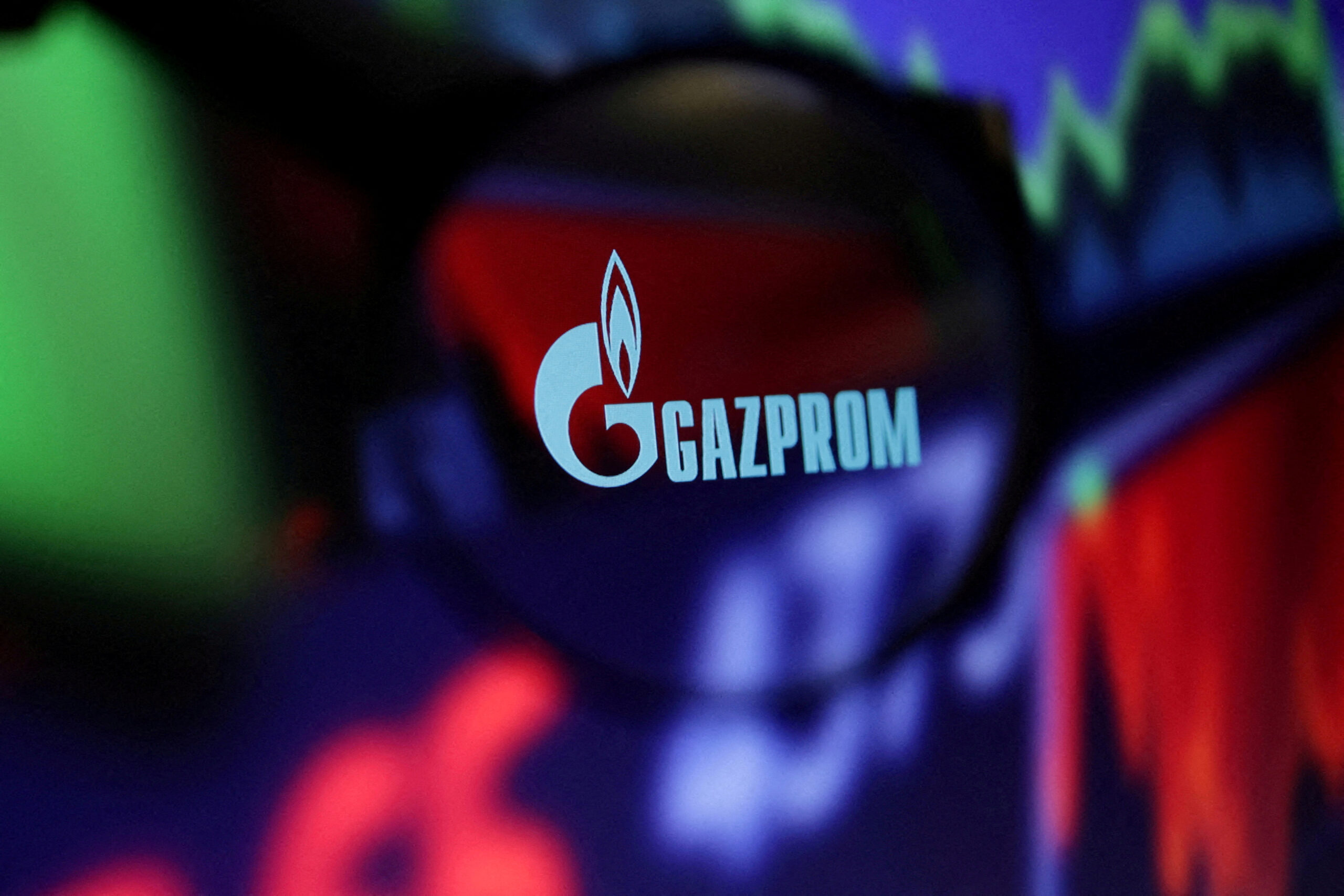 FILE PHOTO: FILE PHOTO: Illustration shows Gazprom logo and stock graph