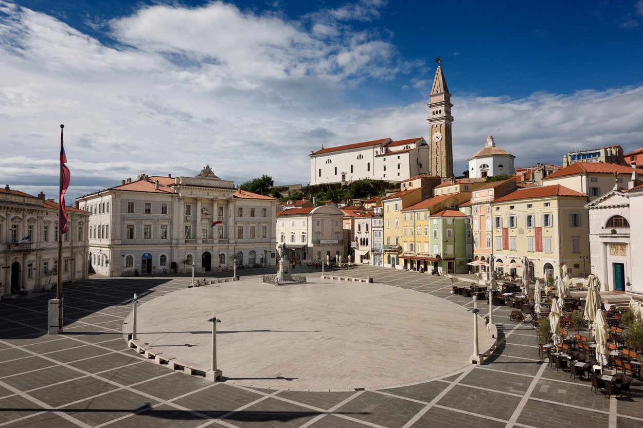 Tartini Square in Piran Slovenia with Courthouse, City Hall, Tartini statue, St. George's Parish Church with baptistry, and St Peter's church