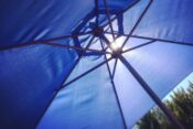 Open blue umbrella in the sun